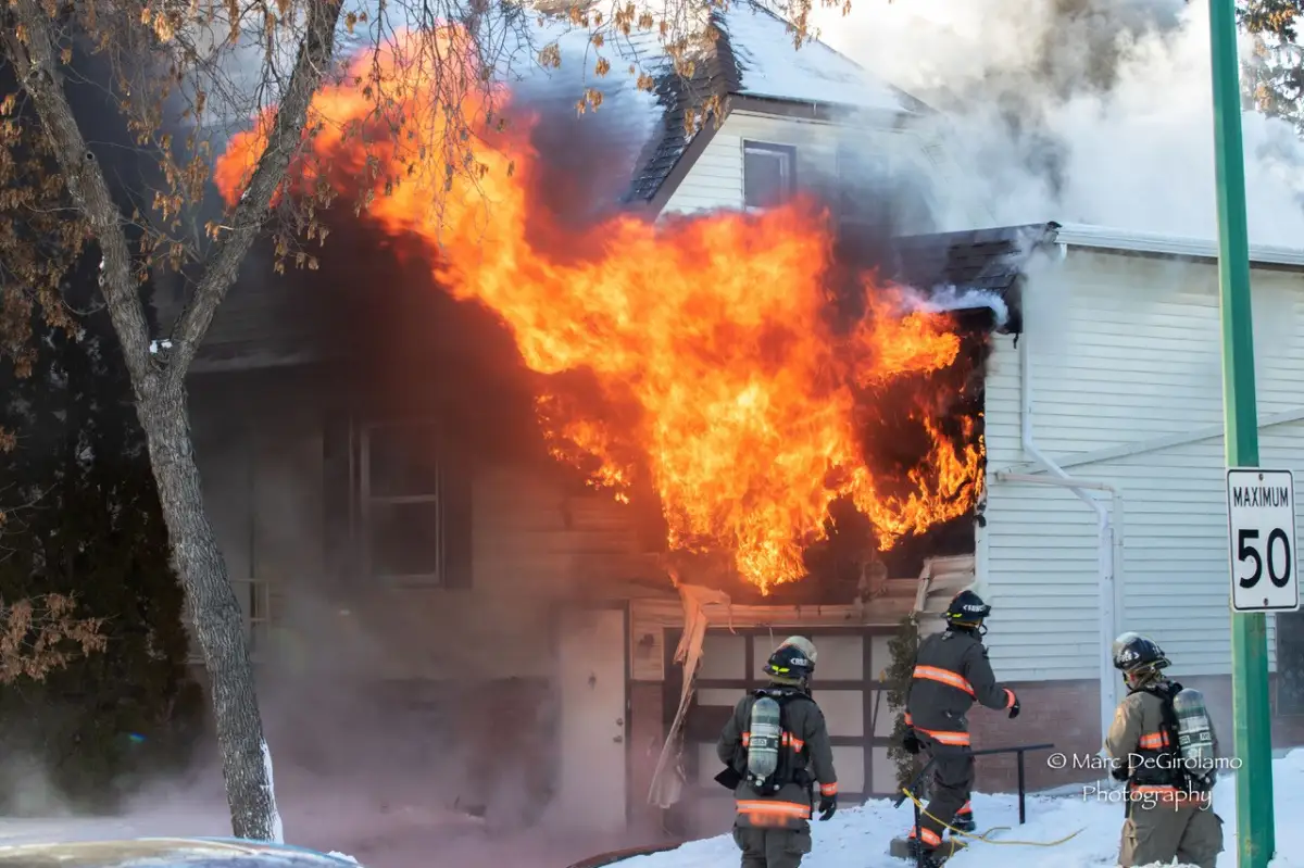 Firefighters battling a house fire in winter